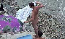 Dark-haired amateur in shades is naked on a beach